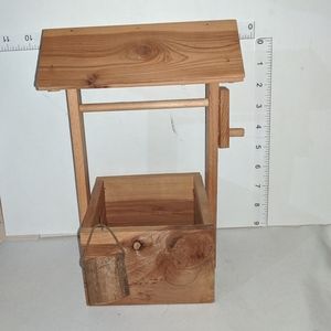 Wood wishing well with bucket